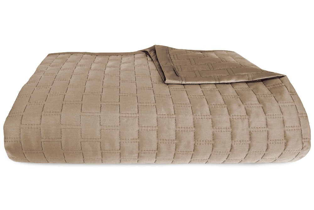 Close up view of a Champagne Colored Luxurious 100% Bamboo Quilted Coverlet neatly folded with one corner partially folded back