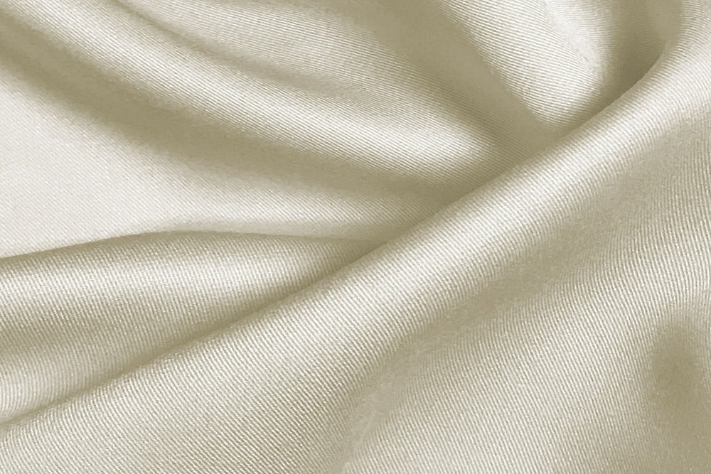 Close up view of silky smooth ivory color bamboo bedsheets fabric