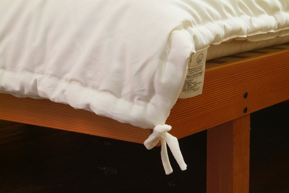 corner view of an all season eco wool comforter and the corner ties of the comforter