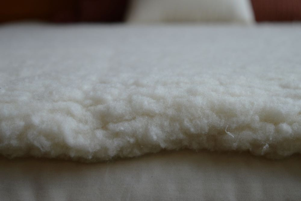 close up of natural happy lamb fleece mattress cover