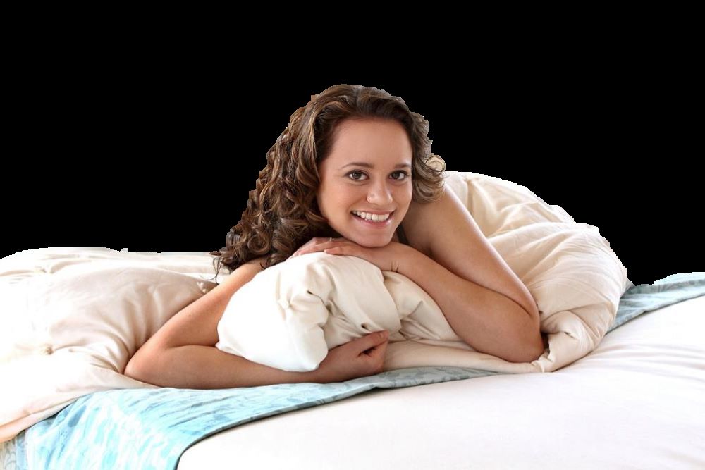 Attractive woman scrunching up an organic sateen sheet and laying on bed